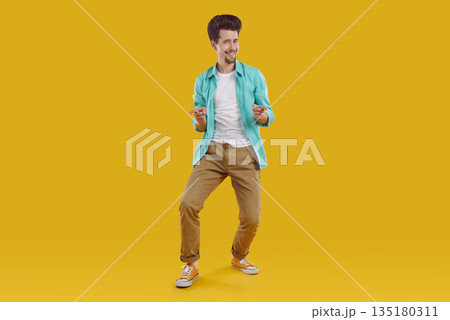 Happy man in casual clothes standing on yellow background, pointing at you and smiling 135180311