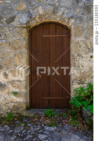 Old wooden doors in St. Hilarion Castle, Northern Cyprus Old wooden doors in St. Hilarion Castle, Northern Cyprus 135180393