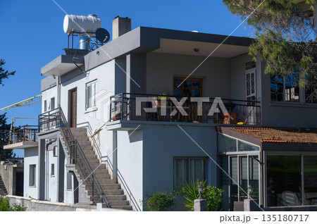 Modern architecture meets sunny days in a vibrant neighborhood overlooking the sea in an urban getaway Modern architecture meets sunny days in a vibrant neighborhood overlooking the sea in an urban getaway 135180717