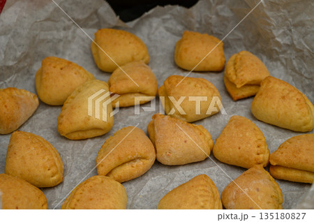 Warm "Goose Feet" Cookies with Icing Sugar on Baking Paper Warm "Goose Feet" Cookies with Icing Sugar on Baking Paper 135180827