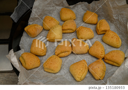 Traditional Goose Foot Shaped Cookies on Baking Parchment Traditional Goose Foot Shaped Cookies on Baking Parchment 135180933