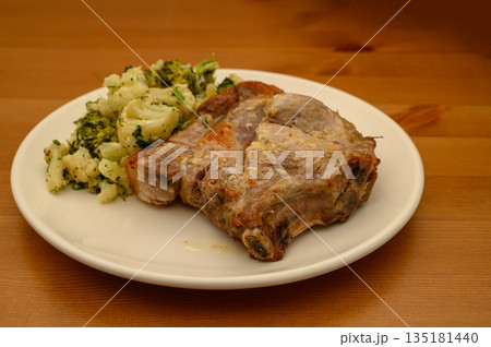 Baked Pork Steak with Cauliflower and Broccoli on Wooden Table 135181440