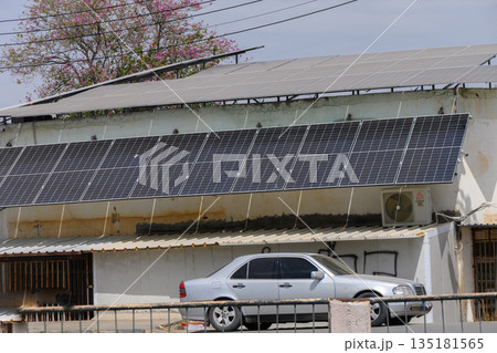 Solar panels generate clean energy on a modern building in a sunlit urban area during the midday hours Solar panels generate clean energy on a modern building in a sunlit urban area during the midday hours 135181565