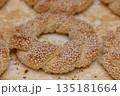 Delicious sesame bagels from a bustling bakery in the heart of the city during a sunny afternoon 135181664