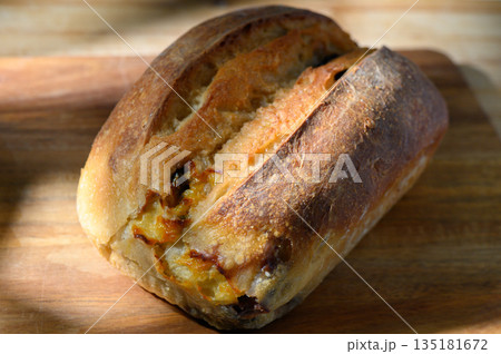 Freshly baked artisan bread showcases golden crust and airy interior, perfect for sharing during 135181672