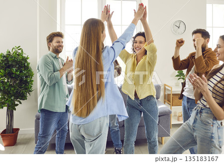 Excited happy friends greeting each other giving high five during meeting at home. Excited happy friends greeting each other giving high five during meeting at home. 135183167