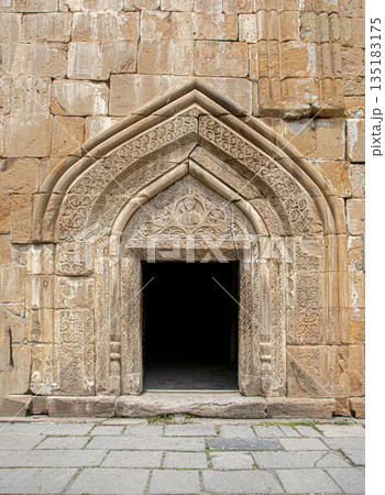 Ananuri complex church portal with intricate stone carvings 135183175