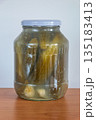 Homemade pickled cucumber in glass jar. 135183413