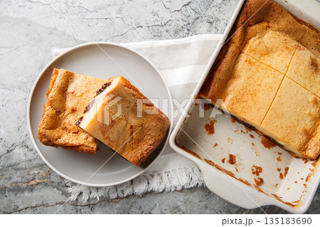 Far Breton is the most representative dessert of its native region of Brittany, where it is also known as farz fourn closeup on the plate. Horizontal top view Far Breton is the most representative dessert of its native region of Brittany, where it is also known as farz fourn closeup on the plate. Horizontal top view 135183690