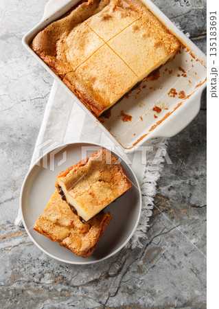 Far Bretonis a traditional cake or dessert a flan style eggs and milk custard with Prunes closeup on the plate. Vertical top view 135183691