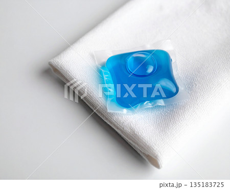 Presentation. Soluble laundry detergent capsule on a neutral linen cloth with empty space for text. Presentation. Soluble laundry detergent capsule on a neutral linen cloth with empty space for text. 135183725