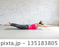Fit Caucasian woman practice Vipareeta Naukasana exercise indoor in loft studio. Inverted boat pose, yoga. 135183805