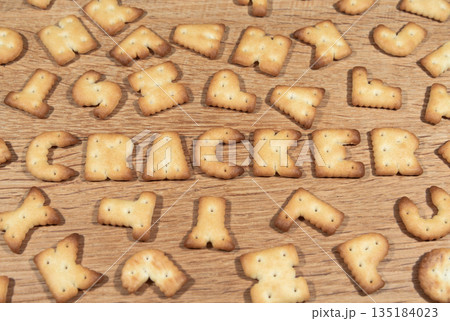 Cracker cookies in the shape of the letters on a wooden surface 135184023