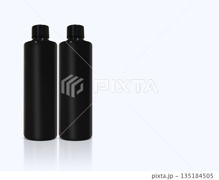 Two black plastic bottles are placed side by side, separated, on a white background. Two black plastic bottles are placed side by side, separated, on a white background. 135184505