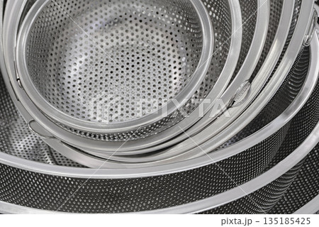 Group of round stainless steel collanders 135185425