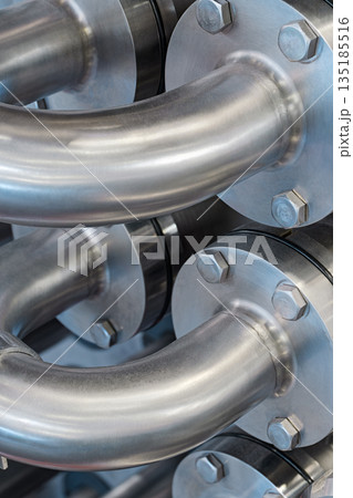 Curved stainless steel pipes, part of industrial cooling system Curved stainless steel pipes, part of industrial cooling system 135185516