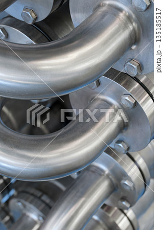 Curved stainless steel pipes, part of industrial cooling system Curved stainless steel pipes, part of industrial cooling system 135185517
