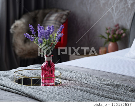 Intimate bedroom vignette showcasing lavender and elegant linens 135185657