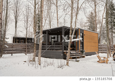 Quiet woodland sanctuary with elevated deck amidst snowy scenery 135185708