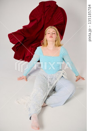 Relaxed graceful woman seated with artistic studio elements Relaxed graceful woman seated with artistic studio elements 135185784