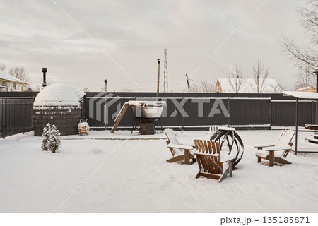 Serene winter evening scene around crackling outdoor fire Serene winter evening scene around crackling outdoor fire 135185871