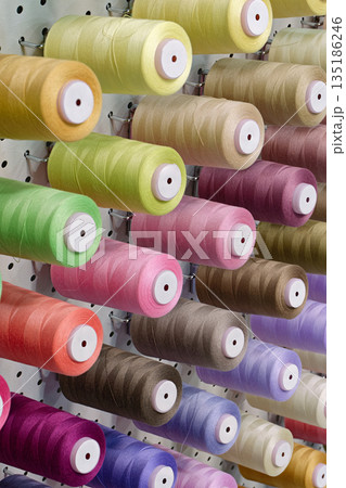 Many spools of thread of different colors 135186246