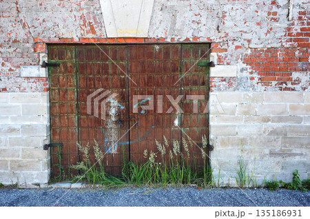 An ancient wooden gate to a storage facility i An ancient wooden gate to a storage facility i 135186931