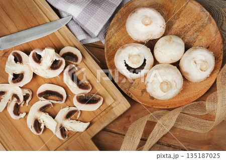 whole mushrooms on a wooden background 135187025