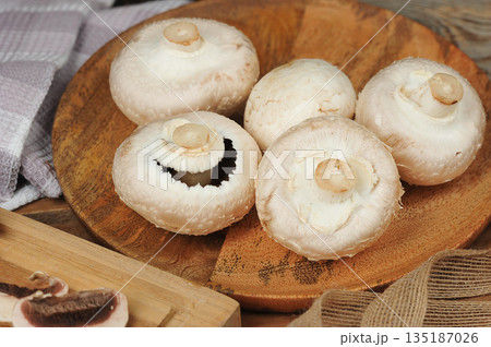 whole mushrooms on a wooden background whole mushrooms on a wooden background 135187026