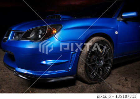 Sleek blue sports car in night close-up. super sport car background with copy space, generic and brandless model car. Sleek blue sports car in night close-up. super sport car background with copy space, generic and brandless model car. 135187313