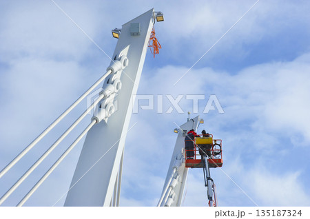 workers work on a lift on the bridge over the Nagatinsky backwater in Moscow workers work on a lift on the bridge over the Nagatinsky backwater in Moscow 135187324