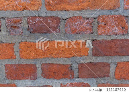 A detailed view of an antique brick wall with a rough, weathered texture. Various shades of burnt clay ranging from bright orange to deep terracotta and brown with grey cement joints. Perfect as a bac A detailed view of an antique brick wall with a rough, weathered texture. Various shades of burnt clay ranging from bright orange to deep terracotta and brown with grey cement joints. Perfect as a bac 135187430