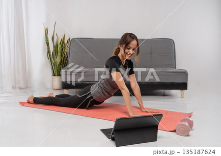 asian fitness coach demonstrating low lunge mobility for strength 135187624
