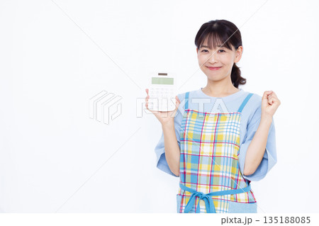 電卓を持ってガッツポーズをしている主婦 電卓を持ってガッツポーズをしている主婦 135188085