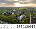 Aerial landscape of small town or village with rows of residential homes and green trees. 135189645
