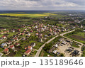 Aerial landscape of small town or village with rows of residential homes and green trees. 135189646
