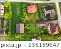 Aerial landscape of small town or village with rows of residential homes and green trees. 135189647