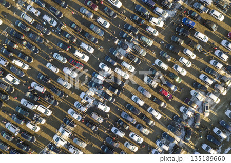 Aerial drone image of many cars parked on parking lot, top view. Aerial drone image of many cars parked on parking lot, top view. 135189660