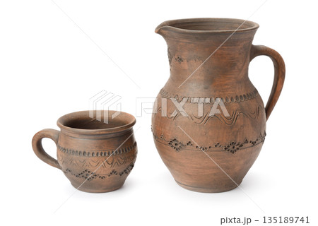 Handmade Clay Jug and Cup Isolated on White Background with Copy Space Showing Traditional Pottery, Rustic Ceramics, Craftsmanship, Earthenware Texture, and Artisan Drinkware Handmade Clay Jug and Cup Isolated on White Background with Copy Space Showing Traditional Pottery, Rustic Ceramics, Craftsmanship, Earthenware Texture, and Artisan Drinkware 135189741