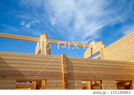 Construction of a log house using planed timber Construction of a log house using planed timber 135189863