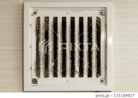Dirty ventilation grille needing cleaning showing accumulation of dust Dirty ventilation grille needing cleaning showing accumulation of dust 135189927