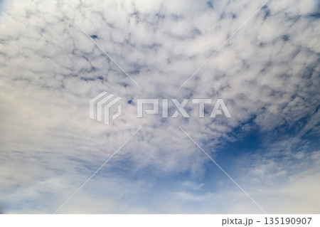 A Beautiful and Expansive Sky Filled with Fluffy White Clouds Like Soft Cotton Fluff A Beautiful and Expansive Sky Filled with Fluffy White Clouds Like Soft Cotton Fluff 135190907