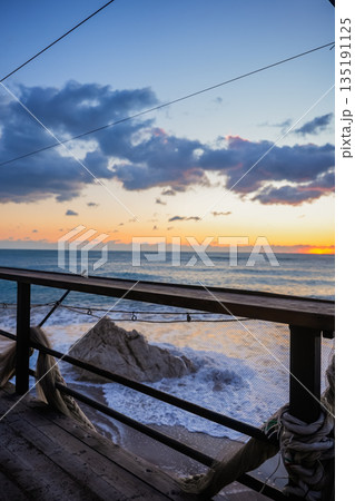 Vertical View of Sunset Over Waves from Terrace 135191125