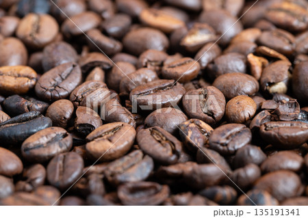 Warm and inviting setting showcasing beans and soothing background, Cozy environment featuring detailed coffee beans against softly blurred atmospheric backdrop 135191341