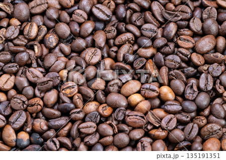 Striking portrayal that highlights boldness and energy of roasted beans, Vivid and impactful image emphasizing strength and vitality of dark roasted coffee beans Striking portrayal that highlights boldness and energy of roasted beans, Vivid and impactful image emphasizing strength and vitality of dark roasted coffee beans 135191351