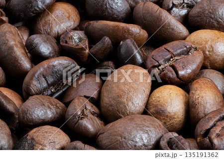 Coffee bean closeup, Closeup of matte roasted coffee beans with intricate details, Detailed macro image showcasing dry matte surface and subtle oil spots on coffee beans Coffee bean closeup, Closeup of matte roasted coffee beans with intricate details, Detailed macro image showcasing dry matte surface and subtle oil spots on coffee beans 135191362