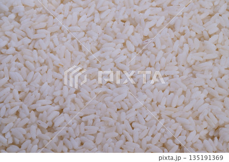 Detailed view of glossy grains, Highresolution photograph capturing shiny rice grains in detail, Closeup shot highlighting smooth and reflective surface of steamed rice grains 135191369