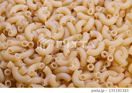 Bulk pasta inventory, Extensive reserve of uncooked elbow macaroni for distribution needs, Vast storage of raw elbow macaroni indicating large supply chain capabilities Bulk pasta inventory, Extensive reserve of uncooked elbow macaroni for distribution needs, Vast storage of raw elbow macaroni indicating large supply chain capabilities 135191383