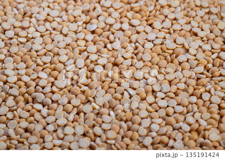 Preparing ingredients for hearty dishes, Yellow split peas prepared for family meal and comforting dishes, Fresh yellow split peas set for making nourishing soups and stews at home 135191424