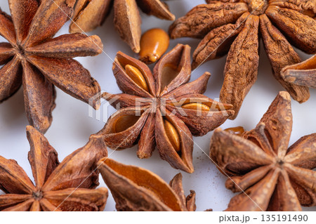 Highresolution macro shot emphasizing rustic kitchen spices and textures, Captivating closeup capturing intricate details of star anise pods and seeds in natural warm lighting Highresolution macro shot emphasizing rustic kitchen spices and textures, Captivating closeup capturing intricate details of star anise pods and seeds in natural warm lighting 135191490